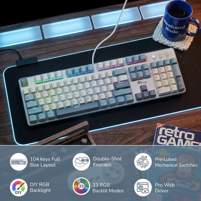 Mechanical keyboard on a desk with a mug and retro gaming magazine, featuring RGB lighting.